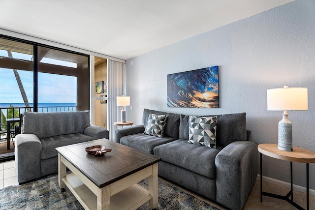 living room with a water view and floor to ceiling windows