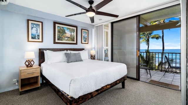 bedroom featuring access to exterior, multiple windows, a water view, and ceiling fan