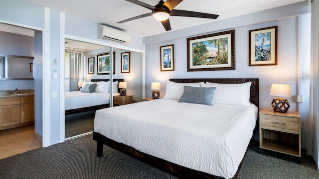 bedroom with carpet, ensuite bath, ceiling fan, sink, and an AC wall unit