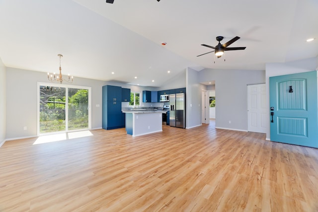 unfurnished living room featuring light hardwood / wood-style flooring, ceiling fan with notable chandelier, and lofted ceiling