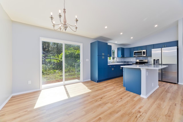 kitchen featuring blue cabinetry, a kitchen island, stainless steel appliances, and light wood-type flooring