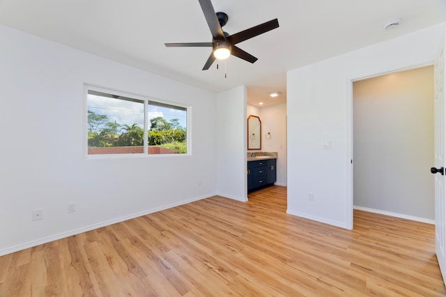 unfurnished bedroom featuring light hardwood / wood-style floors, ceiling fan, and ensuite bathroom