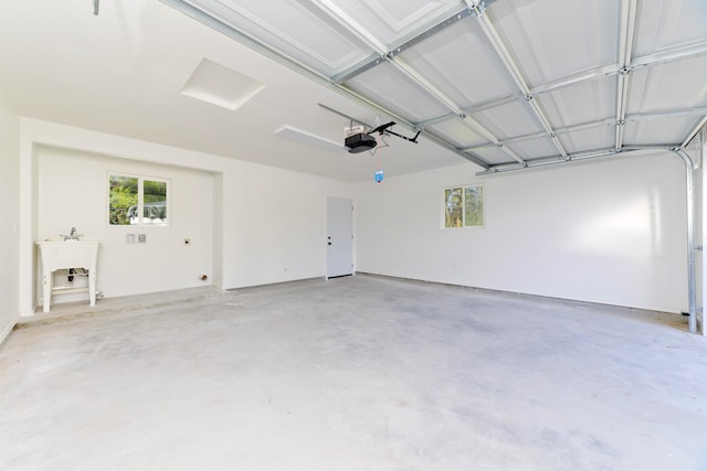 garage featuring a garage door opener and sink