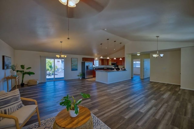 unfurnished living room with dark hardwood / wood-style floors, ceiling fan with notable chandelier, and vaulted ceiling