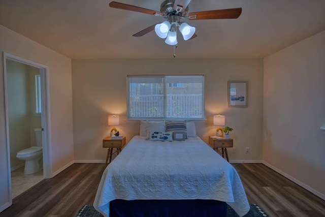 bedroom featuring ceiling fan, ensuite bathroom, and dark hardwood / wood-style floors