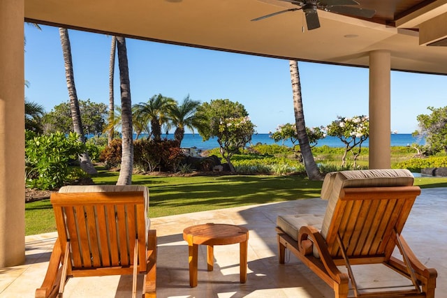 view of patio / terrace with ceiling fan and a water view