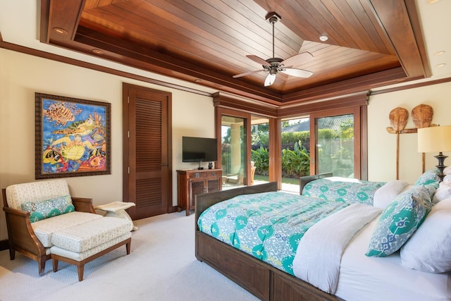 bedroom featuring ceiling fan, wood ceiling, light carpet, and a tray ceiling