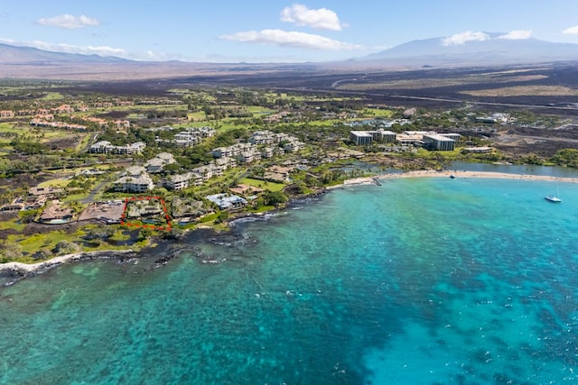 drone / aerial view featuring a water and mountain view