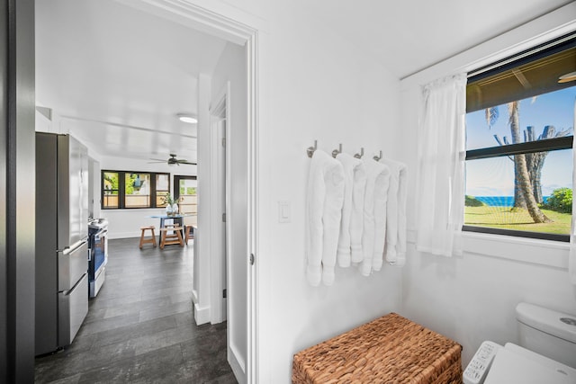 bathroom with ceiling fan and toilet