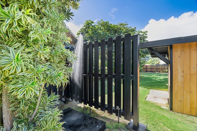 view of gate featuring a lawn