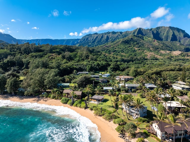 birds eye view of property featuring a water and mountain view and a view of the beach