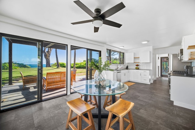 dining area with ceiling fan and sink