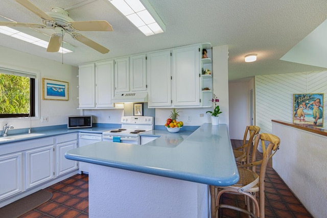 kitchen featuring sink, kitchen peninsula, white appliances, white cabinets, and custom exhaust hood