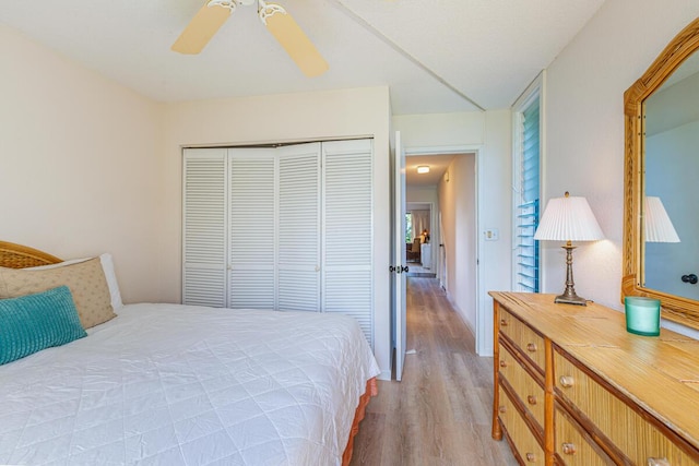 bedroom with ceiling fan, light wood-type flooring, and a closet