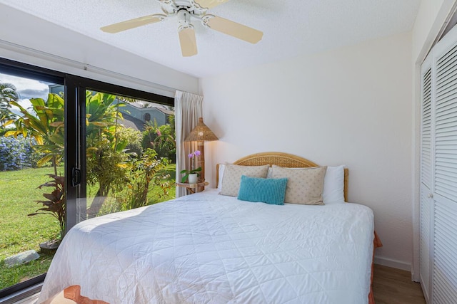 bedroom featuring wood-type flooring, a closet, and ceiling fan