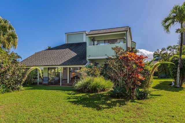 rear view of house with a yard