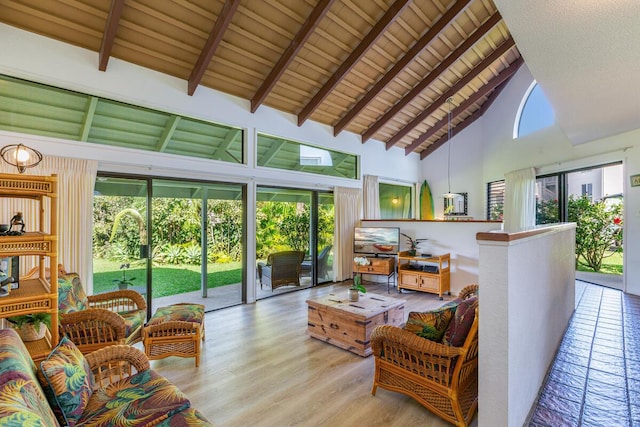 sunroom / solarium featuring vaulted ceiling with beams and wooden ceiling