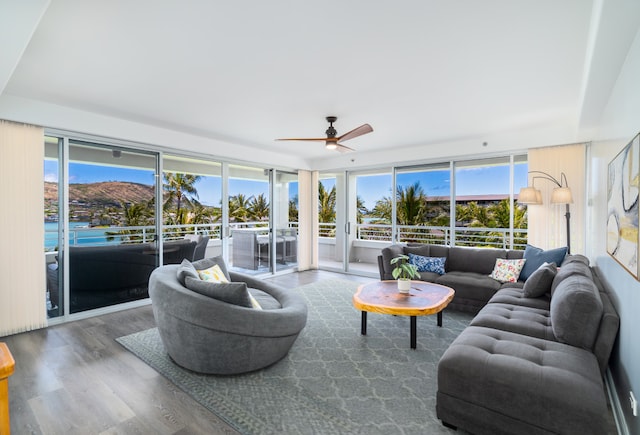 living room featuring hardwood / wood-style flooring, plenty of natural light, and ceiling fan