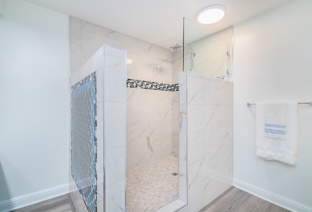 bathroom featuring a tile shower and hardwood / wood-style flooring