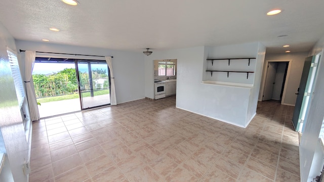 unfurnished living room featuring a textured ceiling