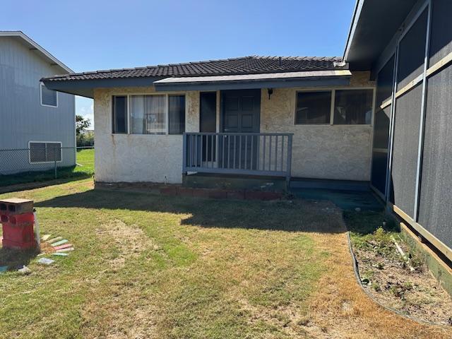 back of house with a lawn