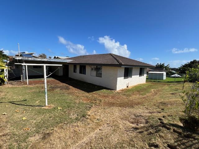 back of property featuring a yard