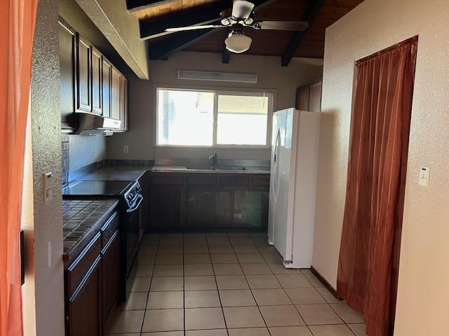 kitchen featuring wood ceiling, sink, light tile patterned floors, white refrigerator, and electric range