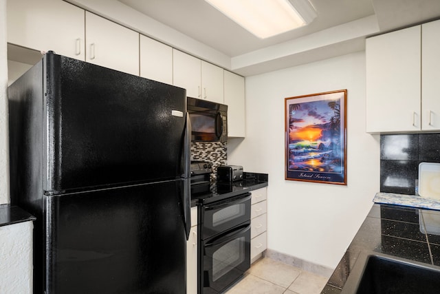 kitchen featuring white cabinetry, decorative backsplash, light tile patterned floors, and black appliances