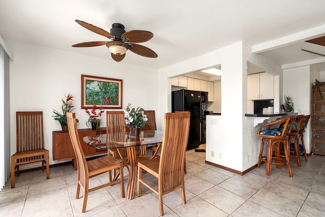 tiled dining area featuring ceiling fan