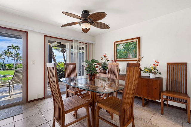 tiled dining space featuring ceiling fan