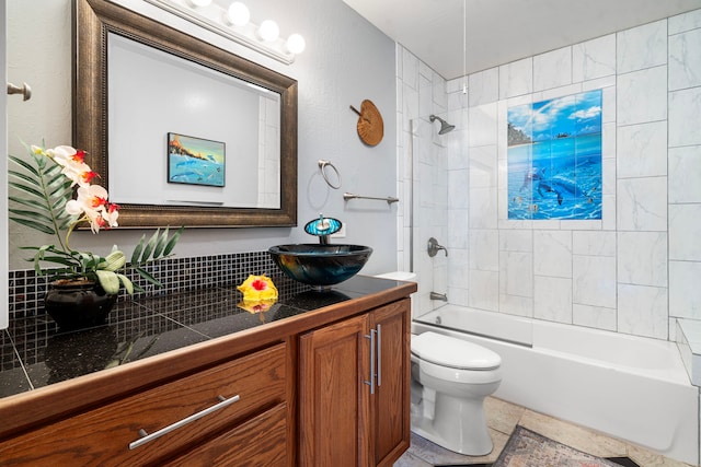 full bathroom with vanity, tiled shower / bath combo, toilet, and tile patterned flooring