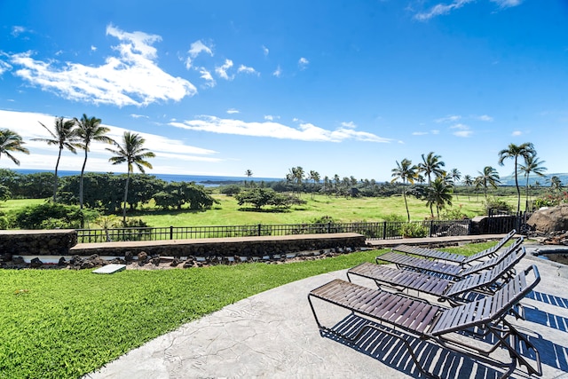 surrounding community featuring a rural view, a patio area, and a yard