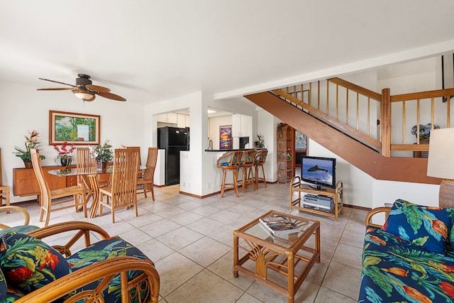 living room with light tile patterned floors and ceiling fan