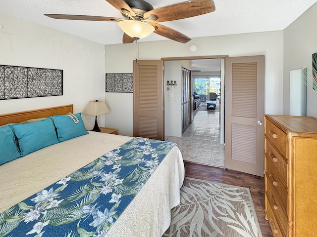 bedroom with a textured ceiling, a closet, and ceiling fan