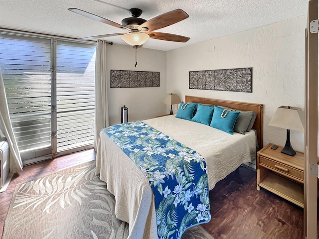 bedroom featuring hardwood / wood-style flooring, ceiling fan, and a textured ceiling