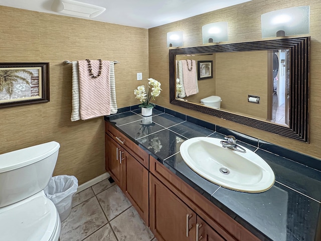 bathroom with tile patterned flooring, vanity, and toilet