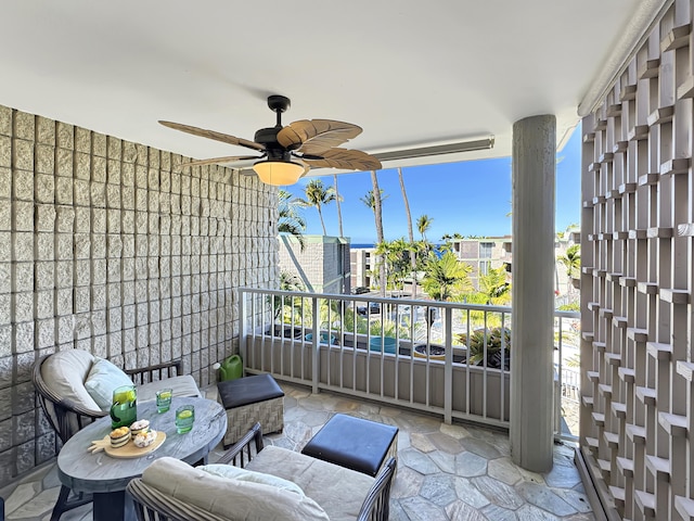 view of patio / terrace with a balcony and ceiling fan