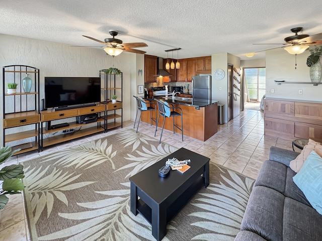 tiled living room with a textured ceiling and sink