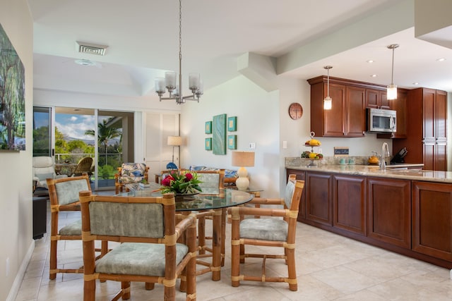 dining area with an inviting chandelier and sink