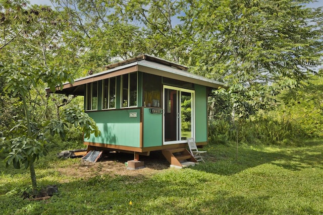 view of outbuilding with a lawn