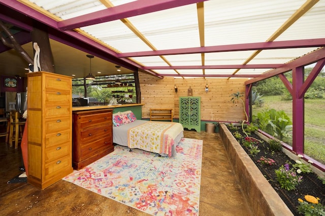 bedroom featuring wood walls