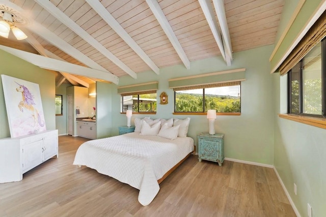 bedroom featuring connected bathroom, lofted ceiling with beams, light hardwood / wood-style flooring, and wooden ceiling