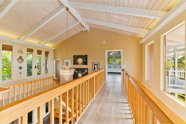 corridor featuring wood ceiling, high vaulted ceiling, a notable chandelier, beamed ceiling, and hardwood / wood-style floors