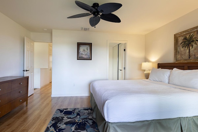 bedroom with ceiling fan and light hardwood / wood-style floors