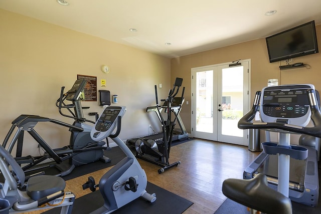 gym featuring dark wood-type flooring and french doors