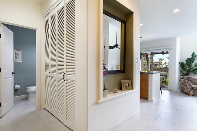 hall featuring light tile patterned flooring