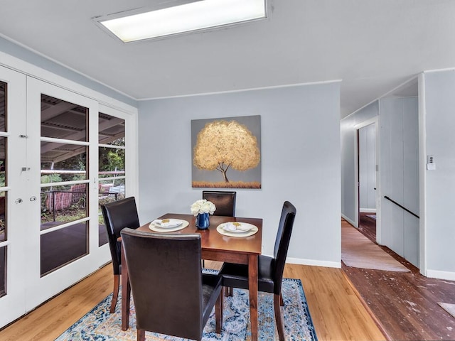 dining room with french doors and hardwood / wood-style floors