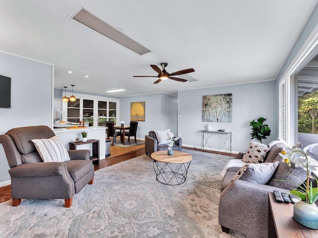 living room featuring french doors, ceiling fan, crown molding, and wood-type flooring