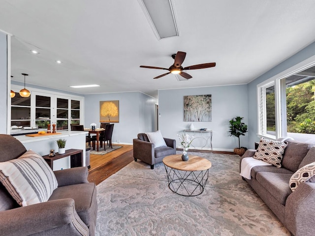 living room with ceiling fan and hardwood / wood-style floors