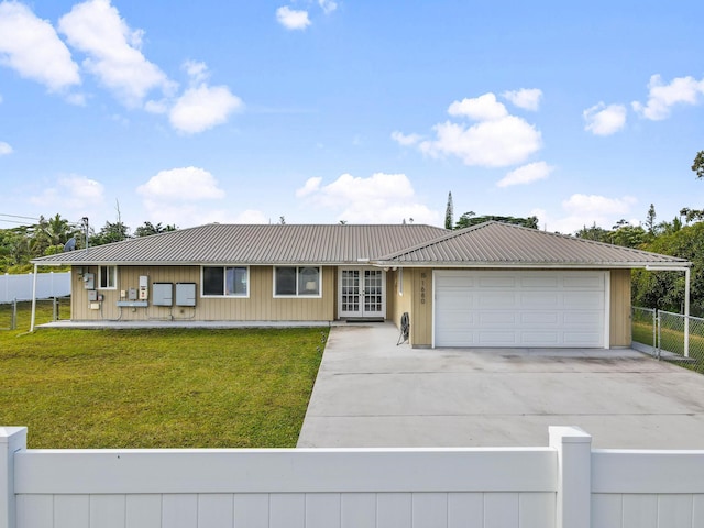 view of front of house with french doors, a front lawn, and a garage